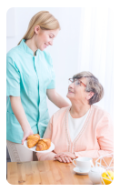 caregiver serving snacks to an elderly woman