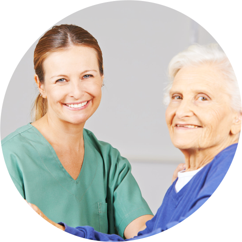 elderly woman with her female caregiver smiling